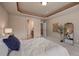 Comfortable bedroom featuring neutral walls, carpeted floor, and a decorative tray ceiling at 9040 Grand Mesa Ave, Longmont, CO 80504