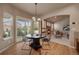 Cozy dining area with a round table, modern light fixture, and views of the backyard at 9040 Grand Mesa Ave, Longmont, CO 80504