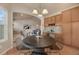 Charming dining area open to the living room, featuring a round table and stylish chairs at 9040 Grand Mesa Ave, Longmont, CO 80504