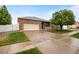 Beautiful brick home with a spacious driveway, well-maintained lawn, and inviting curb appeal at 9040 Grand Mesa Ave, Longmont, CO 80504