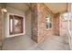 Inviting front porch featuring brick accents and a charming entryway with a decorative door at 9040 Grand Mesa Ave, Longmont, CO 80504