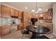 Spacious kitchen and dining area with abundant cabinet space and a modern chandelier at 9040 Grand Mesa Ave, Longmont, CO 80504