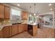 Well-equipped kitchen with wood cabinets, granite countertops, and black appliances at 9040 Grand Mesa Ave, Longmont, CO 80504