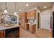 Spacious kitchen featuring light wood floors, granite countertops, and a functional layout at 9040 Grand Mesa Ave, Longmont, CO 80504