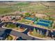 Aerial view of community clubhouse, tennis courts, green space, and parking at 6738 Esmeralda Dr, Castle Rock, CO 80108
