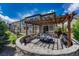 Enjoy outdoor living in this backyard with a custom stone patio, pergola, and landscaped garden at 6738 Esmeralda Dr, Castle Rock, CO 80108