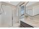 Bright bathroom featuring a glass-enclosed shower and modern vanity with white countertop at 6738 Esmeralda Dr, Castle Rock, CO 80108