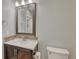 Cozy bathroom features a granite vanity, framed mirror, and neutral walls, perfect for guests at 6738 Esmeralda Dr, Castle Rock, CO 80108