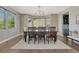 Cozy dining room featuring a statement chandelier, an area rug and a large bay window at 6738 Esmeralda Dr, Castle Rock, CO 80108
