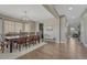 Open concept dining area with a view to the kitchen featuring hardwood floors and modern lighting at 6738 Esmeralda Dr, Castle Rock, CO 80108