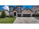 Stunning two-story home featuring stone accents, a three-car garage, and professionally landscaped front yard at 6738 Esmeralda Dr, Castle Rock, CO 80108