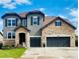 Beautiful two-story home with stone and stucco exterior, three-car garage, and well-manicured lawn at 6738 Esmeralda Dr, Castle Rock, CO 80108