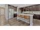 Modern kitchen featuring dark cabinetry, stainless steel appliances, and a large center island with bar seating at 6738 Esmeralda Dr, Castle Rock, CO 80108