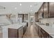 Spacious kitchen with stainless steel appliances, dark wood cabinets, quartz countertops, and center island at 6738 Esmeralda Dr, Castle Rock, CO 80108