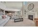 Bright, open-concept living room with fireplace, cathedral ceilings and seamless flow into the kitchen at 6738 Esmeralda Dr, Castle Rock, CO 80108