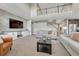 Open-concept living room with a stone accent wall, high ceilings, and staircase to the second floor at 6738 Esmeralda Dr, Castle Rock, CO 80108