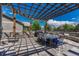 An inviting outdoor patio with a grill, pergola, and charming stone accents at 6738 Esmeralda Dr, Castle Rock, CO 80108