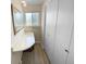Bright bathroom with a vanity sink, large mirror and a closet for extra storage at 13235 Rigel Dr, Lone Tree, CO 80124