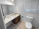 Bright bathroom with updated vanity, toilet, a large mirror and beige tiled floor at 13235 Rigel Dr, Lone Tree, CO 80124