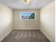 Bright bedroom with soft carpet, freshly painted walls, and a window with neighborhood views at 13235 Rigel Dr, Lone Tree, CO 80124