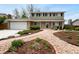 Charming two-story home with brick exterior, well-maintained landscaping, and inviting walkway at 13235 Rigel Dr, Lone Tree, CO 80124