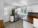 Well-lit kitchen with stainless steel refrigerator, wooden countertops, and stylish backsplash at 13235 Rigel Dr, Lone Tree, CO 80124