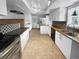 Modern kitchen featuring white cabinetry, stainless steel appliances, and stylish backsplash at 13235 Rigel Dr, Lone Tree, CO 80124