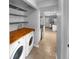 Laundry area with appliances, shelving, and access to a modern kitchen at 13235 Rigel Dr, Lone Tree, CO 80124