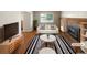 Bright living room with hardwood floors, a brick fireplace, and modern furniture at 13235 Rigel Dr, Lone Tree, CO 80124