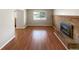 Inviting living room with hardwood floors, brick fireplace, and natural light at 13235 Rigel Dr, Lone Tree, CO 80124
