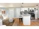 Open kitchen featuring a breakfast bar with granite countertops, pendant lighting, and stainless steel appliances at 3216 N Saint Paul St, Denver, CO 80205