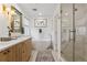 Bright bathroom features double sink vanity, freestanding tub, and large glass shower at 2840 S Bannock St, Englewood, CO 80110