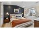 Main bedroom features a paneled accent wall, large window and decorative lighting fixtures at 2840 S Bannock St, Englewood, CO 80110