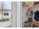 View of the mud room with built-in shelving, bench, hooks, and white wainscoting from front door at 2840 S Bannock St, Englewood, CO 80110