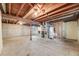 Unfinished basement with exposed beams, concrete floor and block walls with a small window at 772 Urban Ct, Lakewood, CO 80401