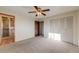 This bedroom has gray carpet, a closet, and an entry to the en suite bathroom at 772 Urban Ct, Lakewood, CO 80401