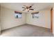 This bedroom has gray carpet, two windows and a ceiling fan with a light at 772 Urban Ct, Lakewood, CO 80401