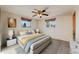 Bright bedroom featuring neutral walls, plush bedding and a ceiling fan with overhead lighting at 772 Urban Ct, Lakewood, CO 80401