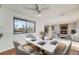 Dining room featuring a modern dining table with seating and views into the living room at 772 Urban Ct, Lakewood, CO 80401