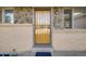 Welcoming front entrance featuring a sturdy security door and classic brick and stone accents at 772 Urban Ct, Lakewood, CO 80401