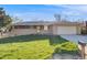 Traditional single-story brick home with a lush green lawn and an attached two-car garage at 772 Urban Ct, Lakewood, CO 80401