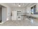 This kitchen features white appliances, updated cabinets and countertops, and recessed lighting at 772 Urban Ct, Lakewood, CO 80401