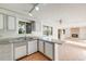 Open-concept kitchen boasts updated cabinets, countertops, appliances, and seamless transition to living space at 772 Urban Ct, Lakewood, CO 80401