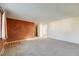Spacious living room featuring soft carpeting, unique accent wall, and a cozy ambiance at 772 Urban Ct, Lakewood, CO 80401