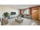 Bright living room featuring a comfortable sofa, stylish furnishings, and a large window for natural light at 772 Urban Ct, Lakewood, CO 80401