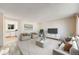 Open-concept living room with a view into the kitchen, featuring modern furnishings and a bright, airy atmosphere at 772 Urban Ct, Lakewood, CO 80401