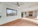 Bright living room featuring wood floors, a fireplace, sliding door and a large window for natural light at 772 Urban Ct, Lakewood, CO 80401