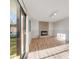 Sun-filled living room with wood floors, brick fireplace, and access to the backyard at 772 Urban Ct, Lakewood, CO 80401
