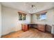 Office with wood floors, two windows and built in desk with drawers and cabinets at 772 Urban Ct, Lakewood, CO 80401