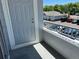A view from the balcony, showing a door, grey railing and parking at 5255 Memphis St # 712, Denver, CO 80239
